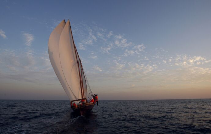 A traditional dhow sails during practice at sunset near Sir Bu Nuayr Island ahead of the Al Gaffal race near Sharjah