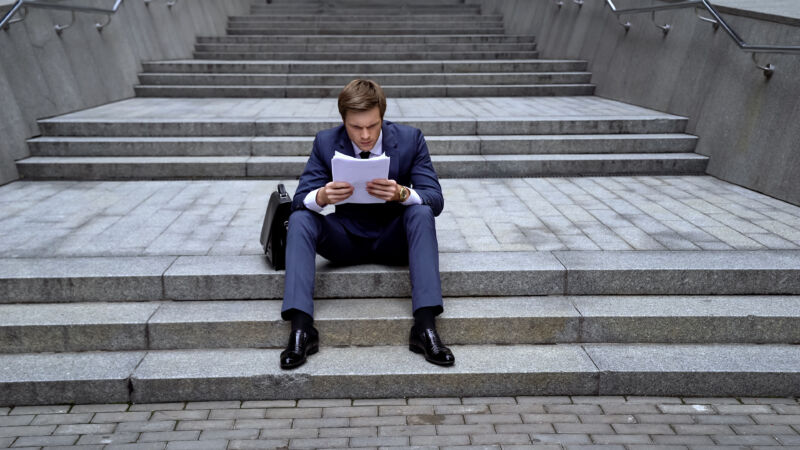 Lawyer sitting on the steps analyzing documents