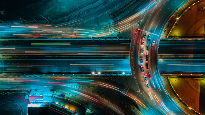 Overhead view of night scene of highway junctures and slow exposure lights