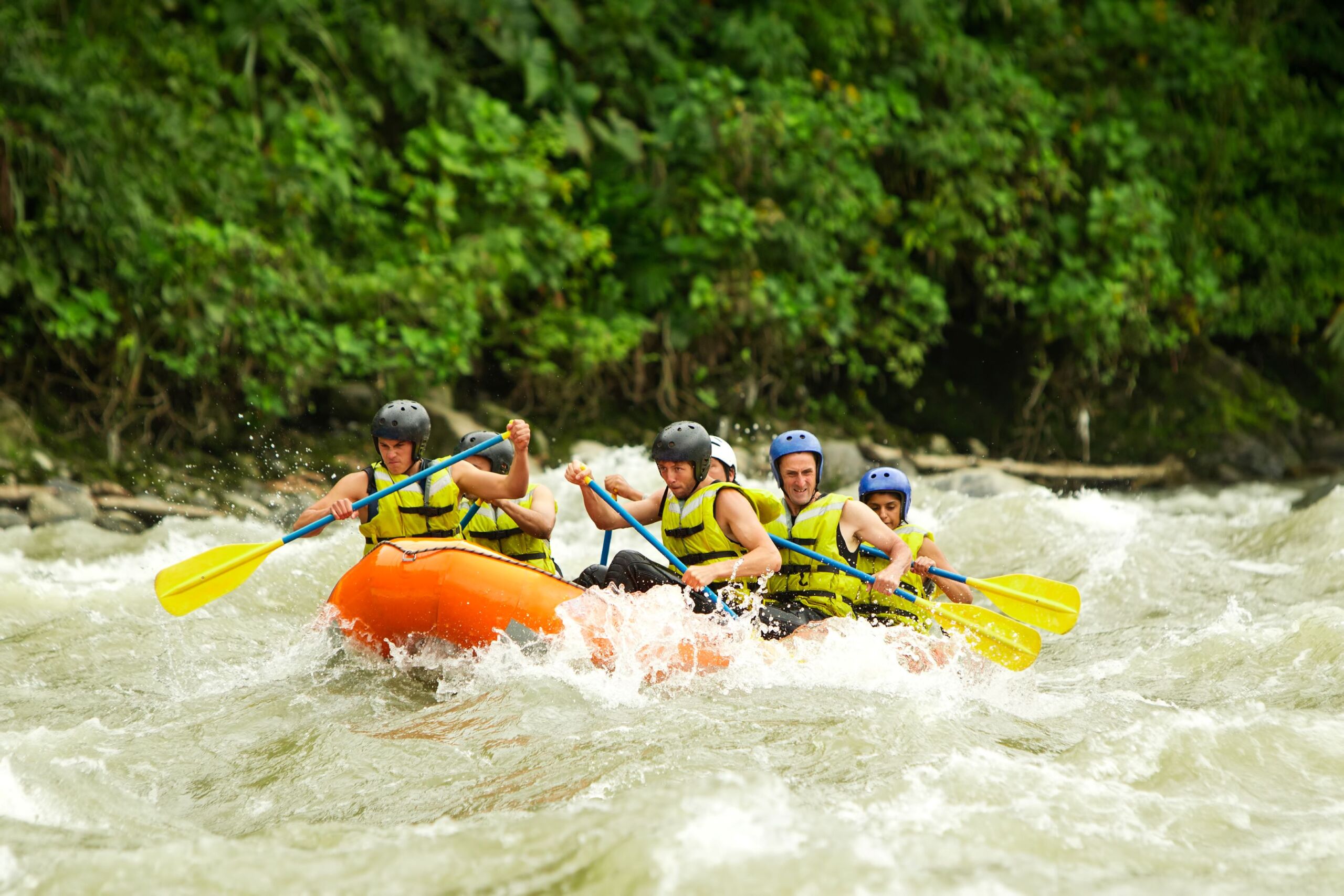 Group of paddlers in orange raft boat