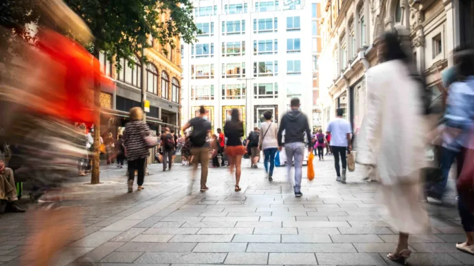 blurred image of people walking on a busy city street