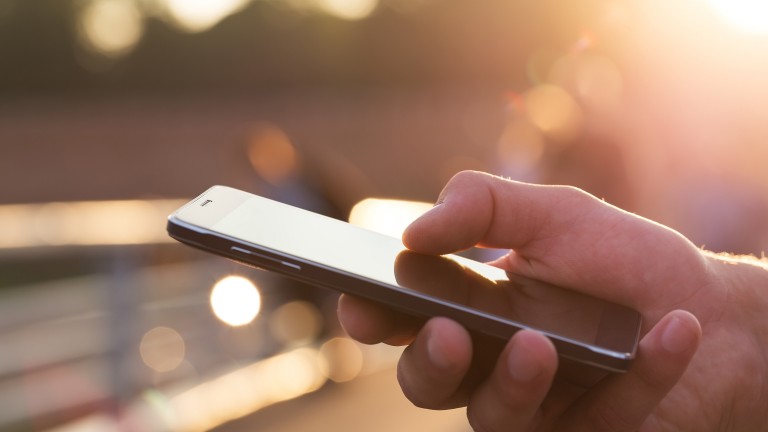 man-using-mobile-phone-outdoor-closeup