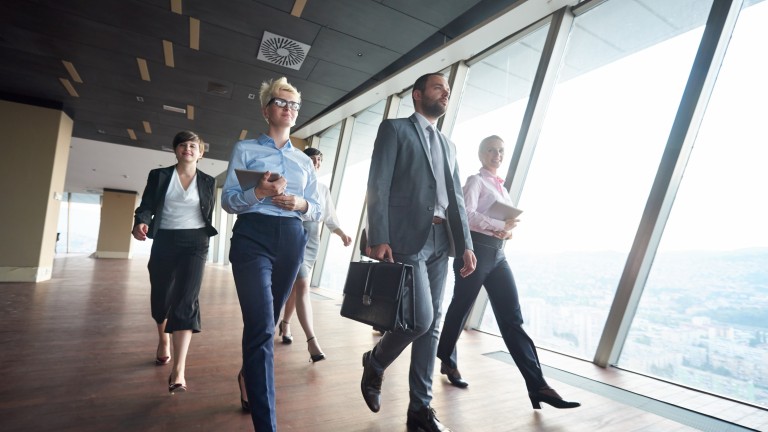 businesspeople  group walking at modern bright office interior